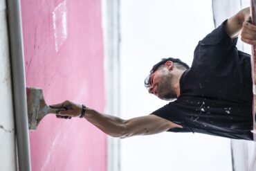 Allan Halley pintant un dels seus murals de gran format.